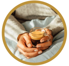 Woman cradling a black Nespresso Coffee