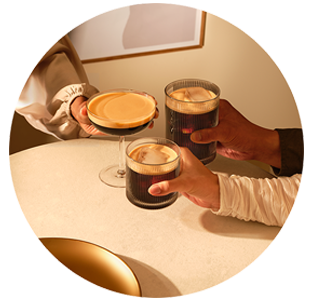 Man on phone with Nespresso Coffee next to him