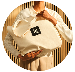 Man working on a laptop with a Nespresso Coffee in a brown circle